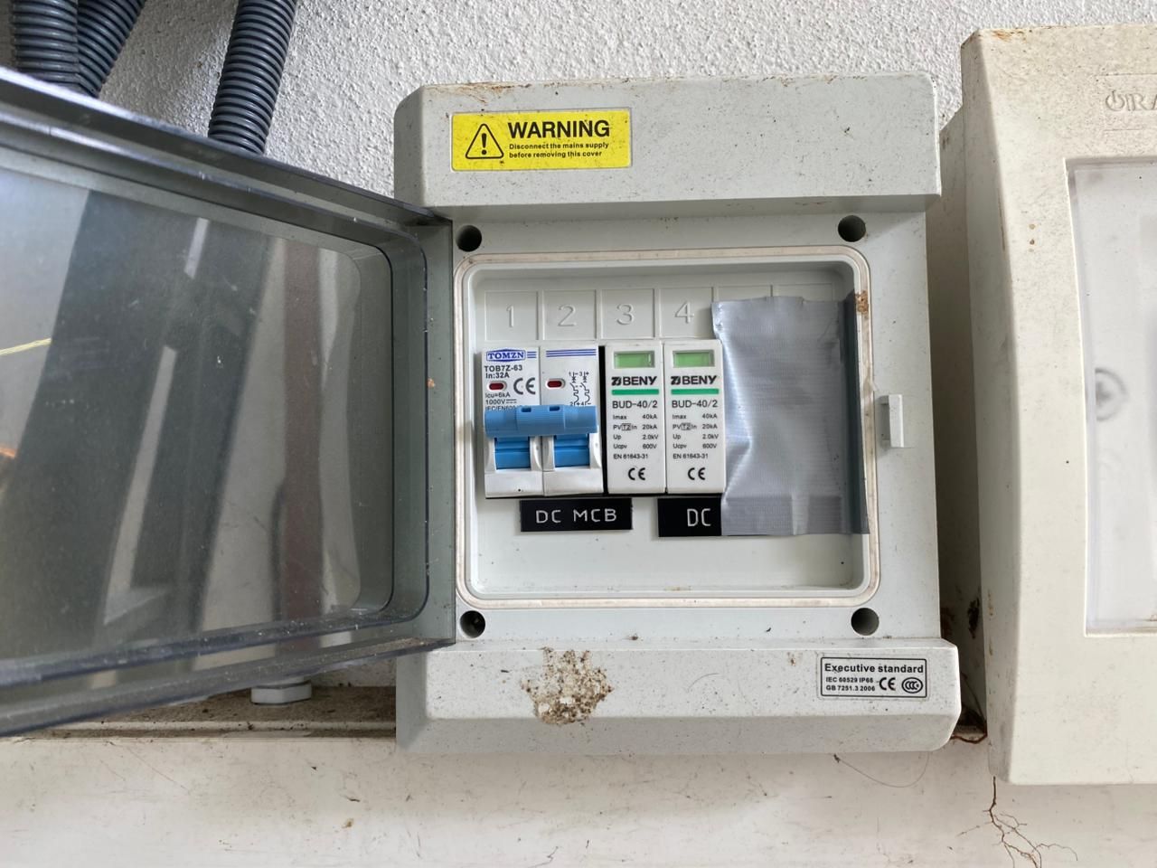 DC isolator enclosure containing a 32 A DC breaker and two DC surge protectors, labelled DC MCB