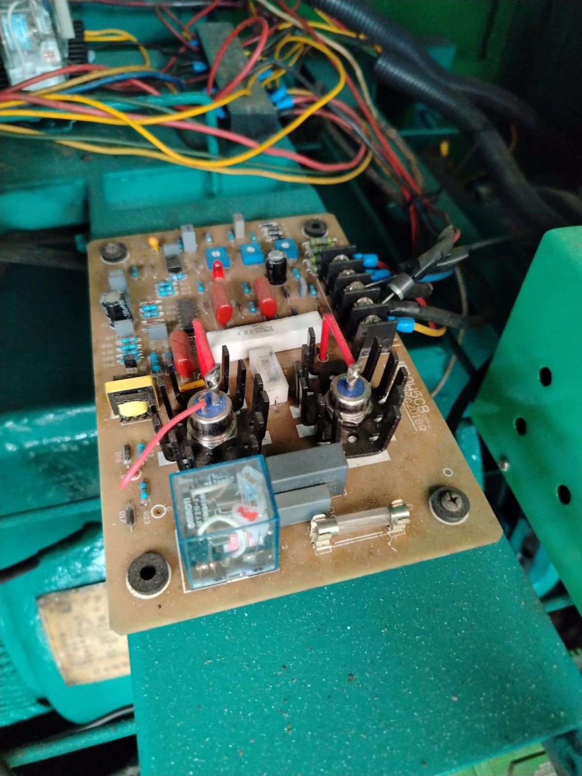 Generator control board removed for inspection, with its wiring loom visible