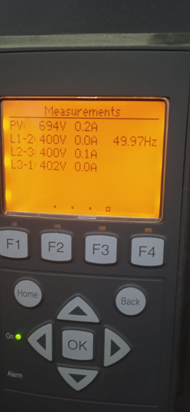 SMA commercial inverter display showing PV string voltage and three-phase measurements