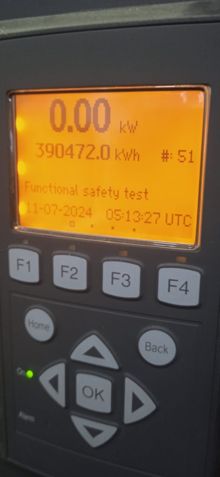SMA commercial inverter display showing lifetime energy of 390,472 kWh and a logged functional safety test