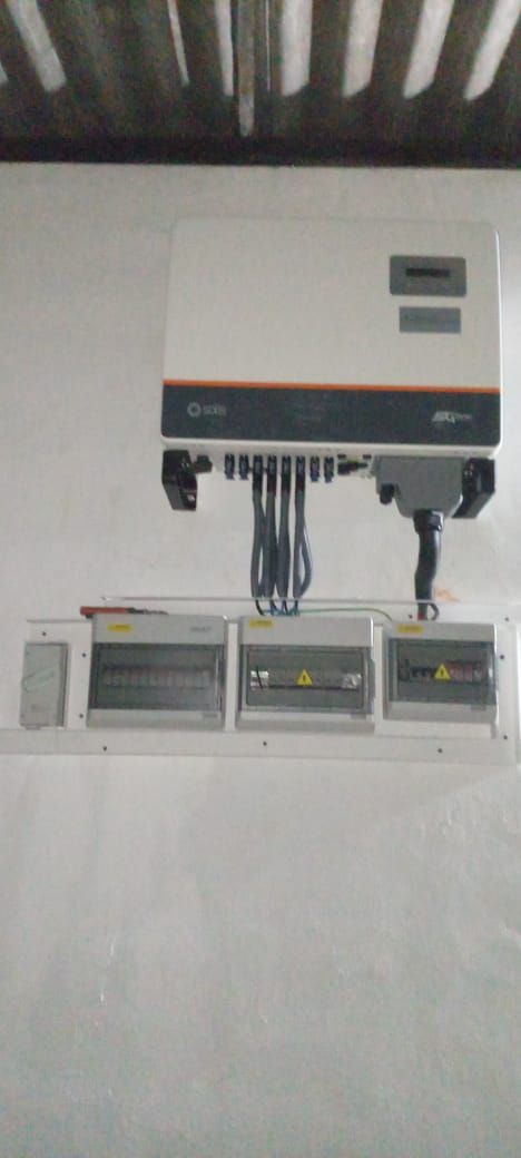 Three-phase Solis inverter with four protection enclosures mounted beneath it